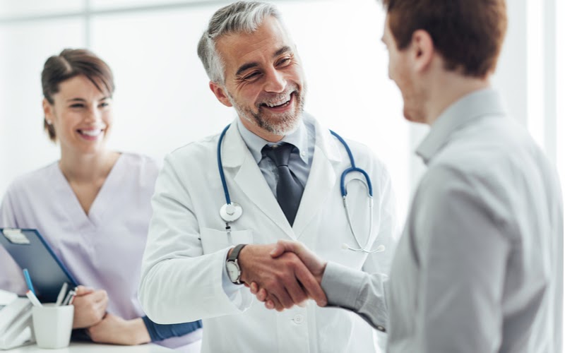 Physicians-electronic-signature Physician shaking hands with a patient