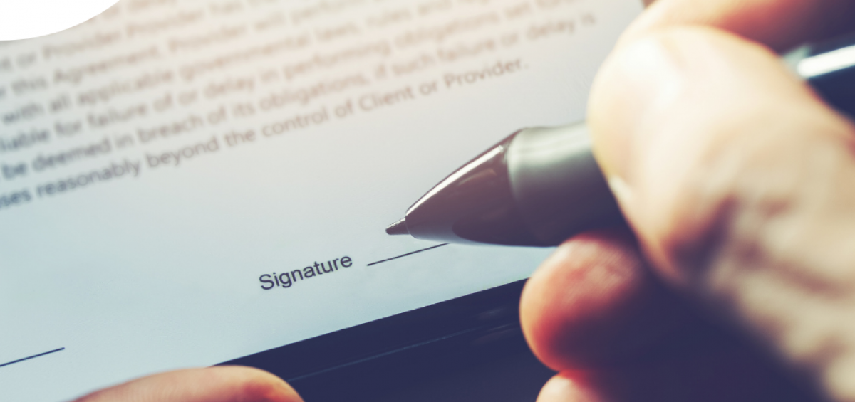 Image of someone signing using a signature maker